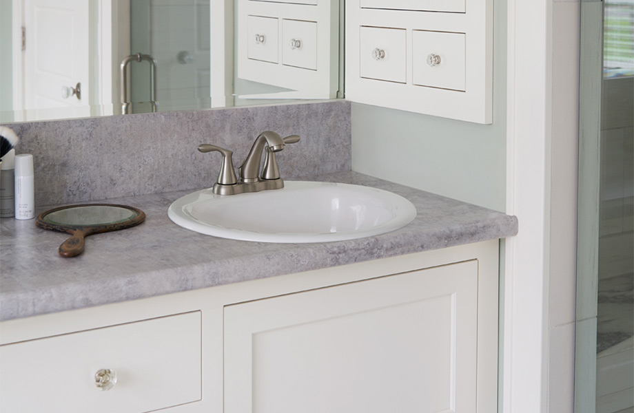 Bathroom with full width mirror and round sink bowl