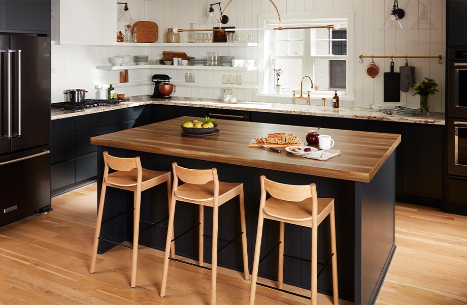 Modern kitchen with dark cabinets and a woodgrain island with stools