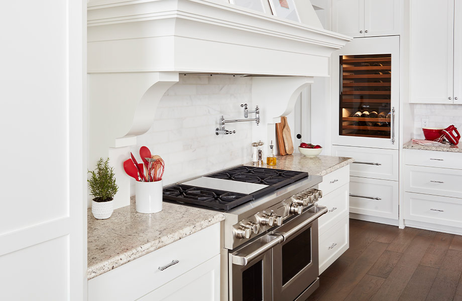 A white modern country kitchen with stainless steel appliances